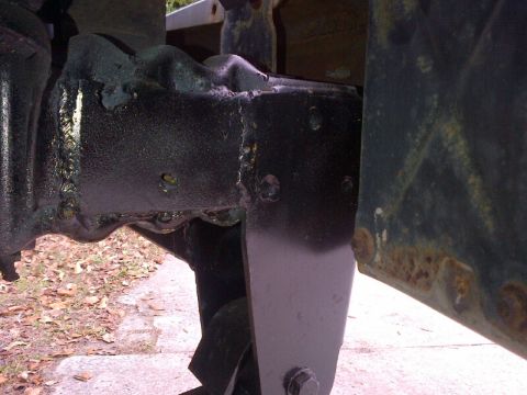 1994 Ford Bronco - Close-up view of vehicle frame and suspension components, showing signs of rust and black paint.