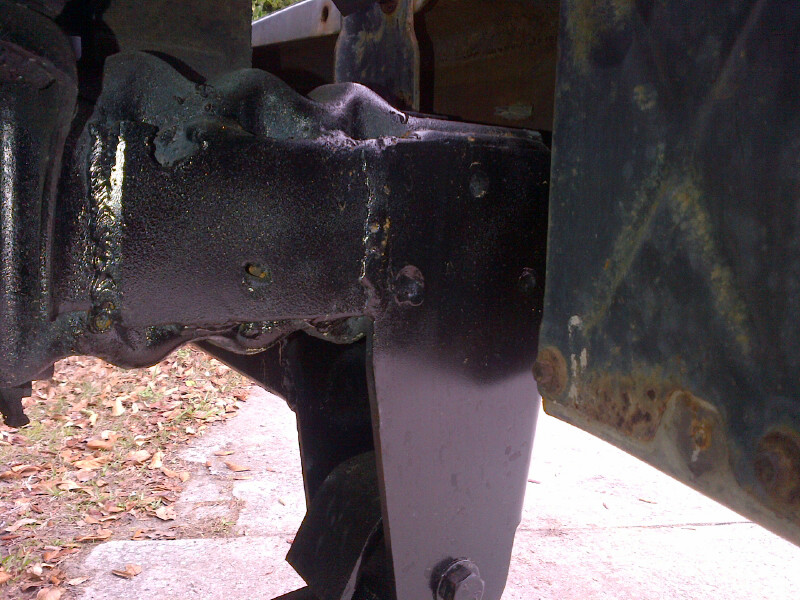 Black painted metal frame and suspension parts with rust visible on the right side panel