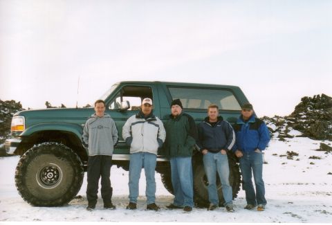 1996 Ford Bronco - Five men pose in front of a lifted 1996 Ford Bronco in a snowy, rocky area.