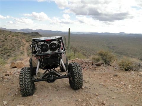 1967 Ford Mustang - This custom off-road buggy features an exposed engine and large tires, captured in a desert landscape.