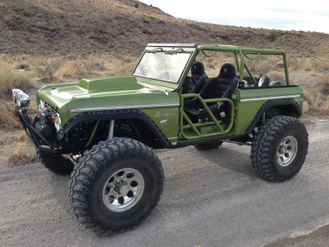 1967 Ford Mustang - This modified off-road vehicle features a prominent roll cage and oversized tires, suggesting a custom build.