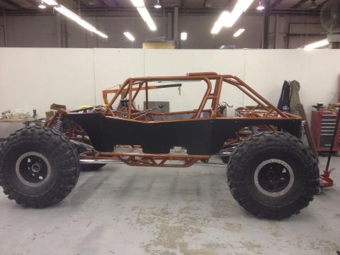 1967 Ford Mustang - Custom off-road buggy in a workshop, showing its frame and large tires.
