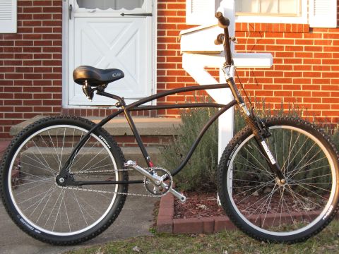 1994 Ford Bronco - A custom cruiser bicycle with a unique frame design is shown parked on a lawn in front of a house.