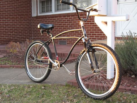 1994 Ford Bronco - A custom bicycle with a unique frame design sits outside a brick house.