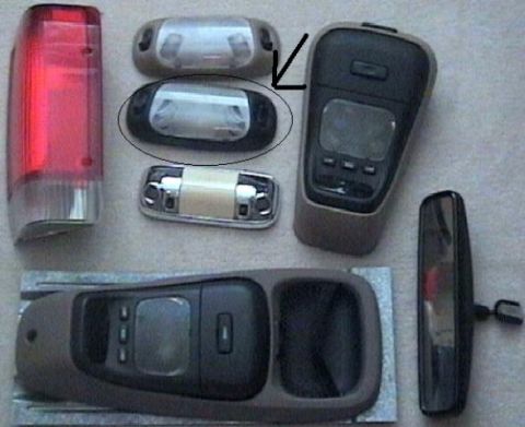 1993 Ford Bronco - Various interior vehicle light components and a rearview mirror are laid out on a surface.