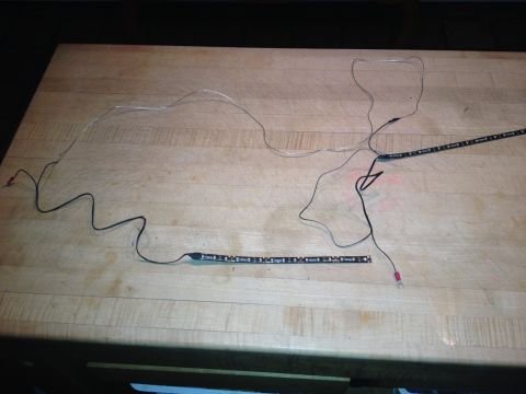 1979 Ford Bronco - LED light strips and their associated wiring are spread out on a wooden table.
