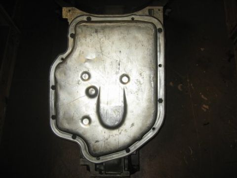 1967 Pontiac Grand Prix - A transmission oil pan is shown from above, with a dark background.