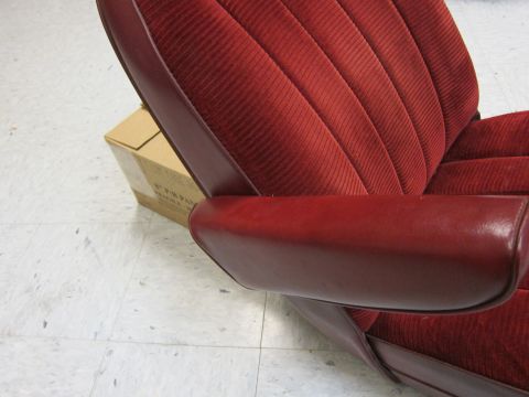 1991 Ford LTD Crown Victoria - Close-up of a red velour car seat a leather armrest and ribbed seat back upholstery.
