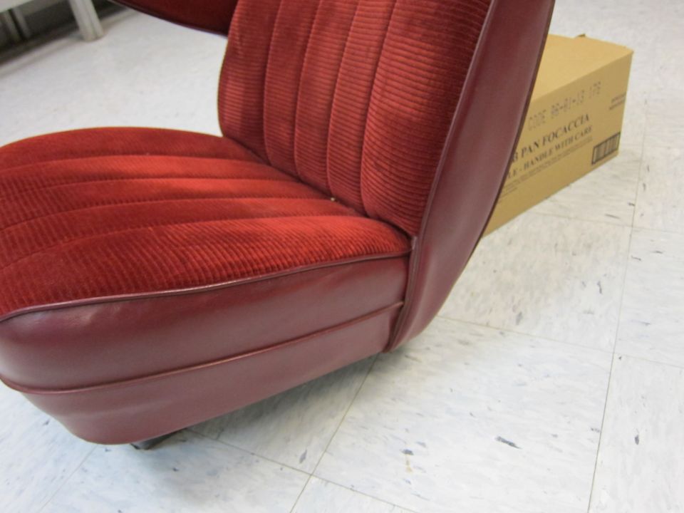 Red velour car seat with burgundy vinyl trim, box in background