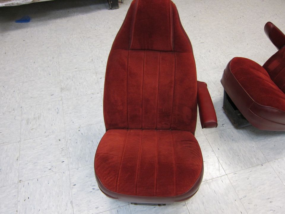 Red velour bucket seats with armrests