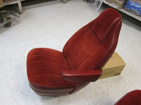 1991 Ford LTD Crown Victoria - A single car seat with red fabric and leather trim is shown indoors.