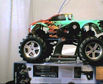 1980 Ford Bronco - A remote control monster truck with colorful graphics sits on top of its packaging.