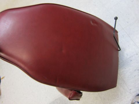 1991 Ford LTD Crown Victoria - This is a close-up view of a red vinyl seat cushion, possibly from a vehicle or furniture.