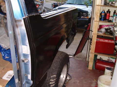 1990 Ford Bronco - Body panel repair in progress on a 1990 Ford Bronco, with a white Ford truck visible in the background.