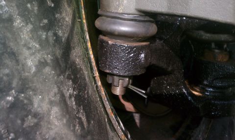 1995 Ford Bronco - Ball joint assembly with cotter pin and castle nut visible.