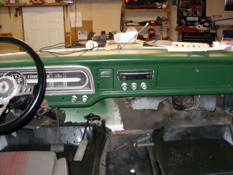 1967 Ford F-250 - Interior view of a 1967 Ford F-250 dashboard and steering wheel, showing the instrument cluster and radio.