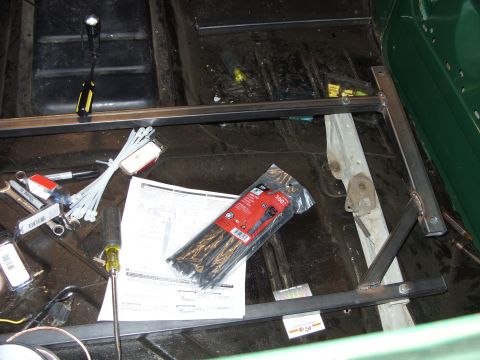 1967 Ford F-250 - Vehicle interior showing a metal frame installation with tools and zip ties on the floor.