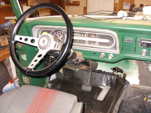 1967 Ford F-250 - The interior of a vintage truck, a green dashboard, steering wheel, and instrument panel.