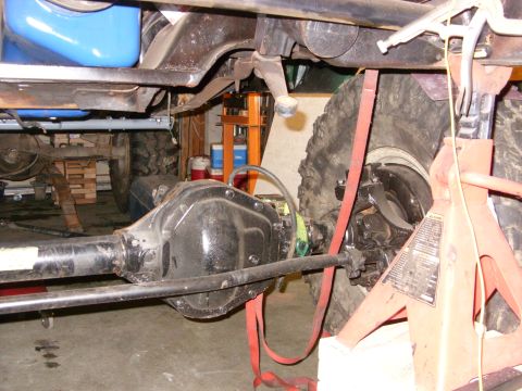 1967 Ford F-250 - Close-up view of a truck's rear axle and suspension system, supported by jack stands.