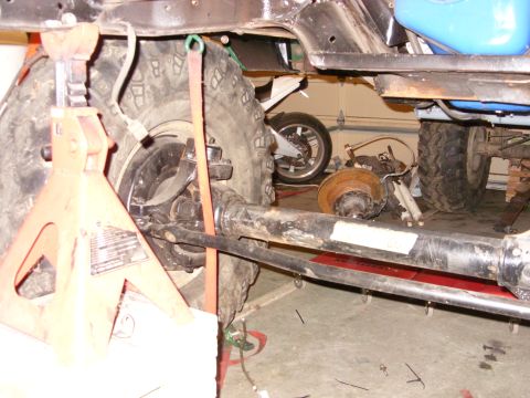 1967 Ford F-250 - Underbody view of a vehicle undergoing maintenance or repair, showing suspension and frame elements.