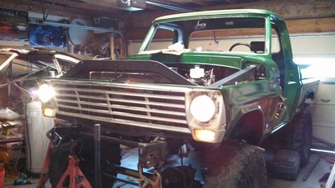 1967 Ford F-250 - A green 1967 Ford F-250 pickup truck is undergoing repairs in a garage.