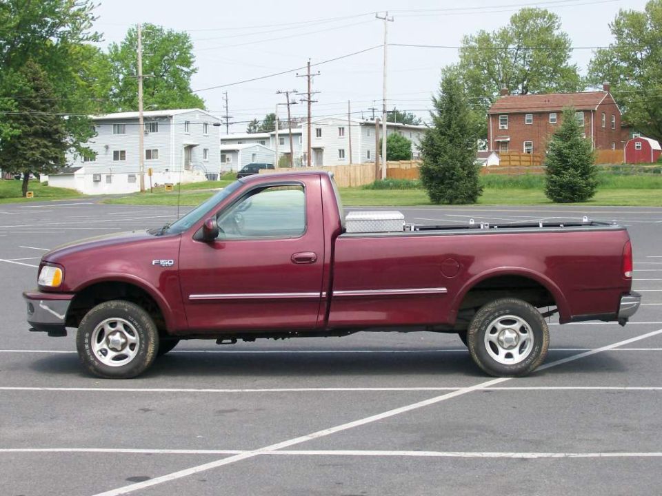 1997 Ford F-150 pickup truck, side view, parked in a lot