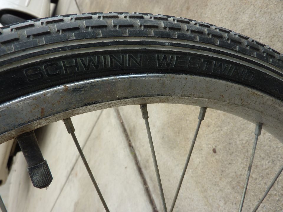 Close-up of a bicycle wheel showing a Schwinn Westwind tire and spokes