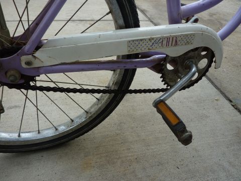 1900 Yugo GVX - Close-up of a bicycle's chain guard and pedal, showing the "lil CHIK" label.