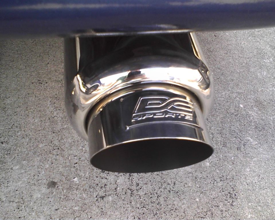 Polished chrome D2 Sports exhaust tip under a dark blue bumper
