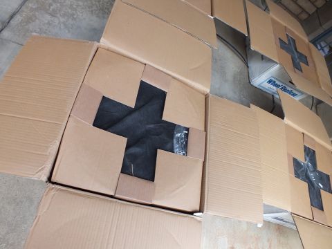 2003 Ford Crown Victoria - Open carton with a black tape X over a wrapped item; a Wheel Replicas labeled box sits alongside.