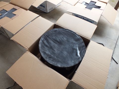 2003 Ford Crown Victoria - Black alloy wheel sealed in plastic inside an open box, surrounded by Wheel Replicas shipping cartons.