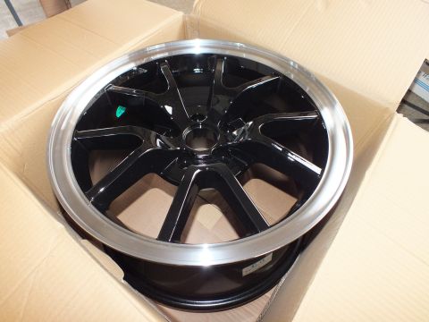 2003 Ford Crown Victoria - Black machined-lip alloy wheel marked with a small green dot sticker resting in its carton