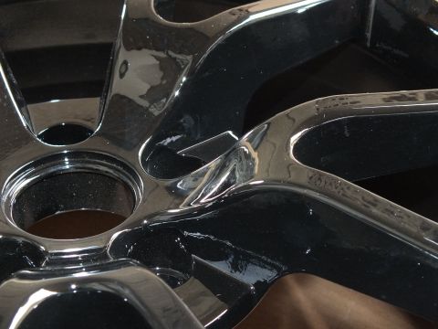 2003 Ford Crown Victoria - Extreme close-up of polished black chrome wheel spokes and the central hub opening
