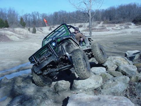 1992 Ford Bronco - Off-road vehicle tackling a challenging rocky obstacle course.