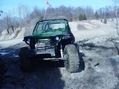 1992 Ford Bronco - This modified Suzuki is equipped for terrain, a roll cage and aggressive tires.