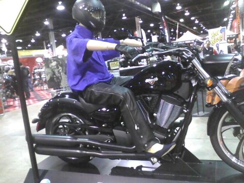 2003 Ford Crown Victoria - A mannequin dressed in riding gear sits on a black motorcycle on display.