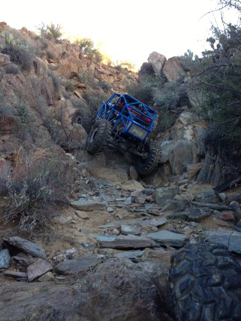 1966 Ford Bronco - Custom off-road buggy navigates a challenging rocky incline in a desert environment.