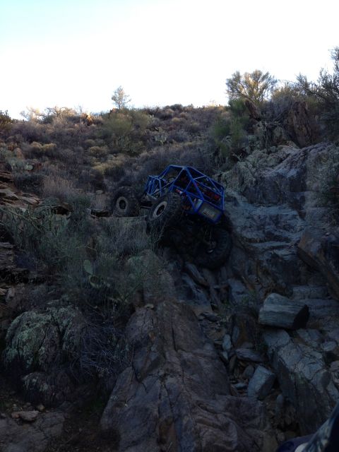 1966 Ford Bronco - Off-road buggy navigating a challenging rocky terrain on a hillside.