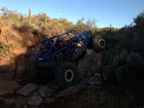 1966 Ford Bronco - Custom off-road buggy navigates a challenging rocky obstacle course in a desert environment.