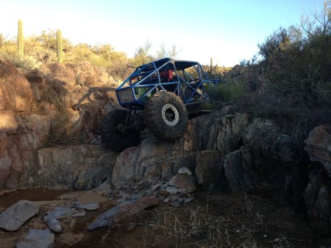 1966 Ford Bronco - Custom rock crawler vehicle navigating difficult terrain with large tires.
