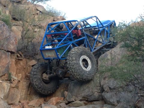 1966 Ford Bronco - Custom off-road buggy navigates a challenging rocky incline.