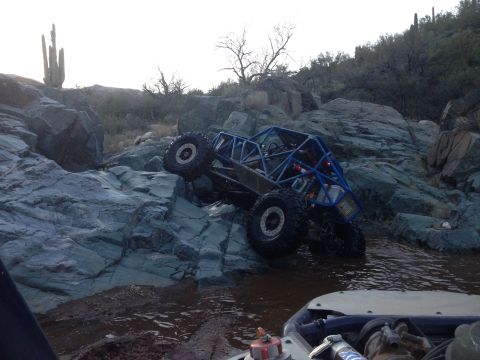 1966 Ford Bronco - Custom off-road buggy navigates a challenging rocky obstacle course in a desert environment.