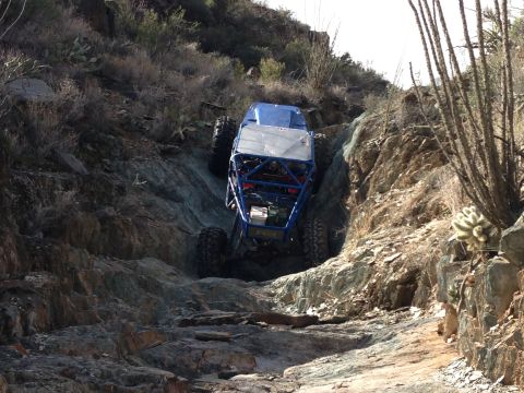 1966 Ford Bronco - This custom buggy navigates a challenging rocky trail in a desert environment.