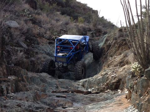 1966 Ford Bronco - A custom-built off-road buggy tackles a challenging rocky trail in a desert environment.