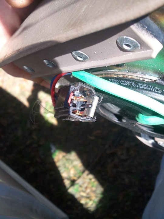 Airbag sensor connector with wires and a green conduit