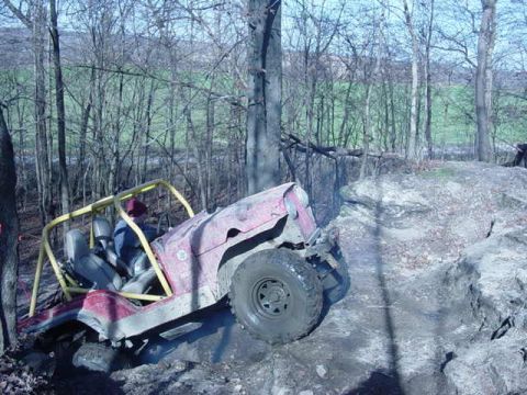 1992 Ford Bronco - A driver navigates a off-road trail in a modified Jeep.
