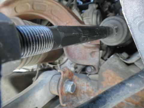 2000 Lincoln Continental - Close-up view of a vehicle's tie rod end, showing the ribbed boot and hex-shaped shaft.