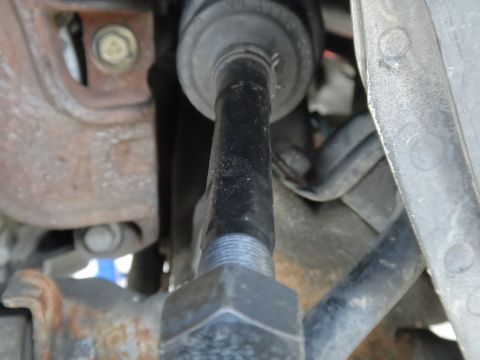 2000 Lincoln Continental - Close-up view of a car's steering linkage and suspension components.