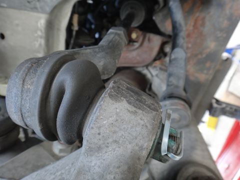 2000 Lincoln Continental - This image shows a close-up view of a vehicle's suspension system, focusing on a rubber boot and metal components.
