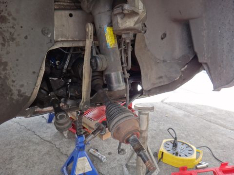 2000 Lincoln Continental - Close-up view of a vehicle's front suspension system undergoing maintenance.